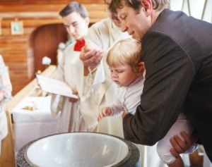 A one year old boy being baptized.