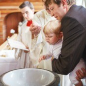 A one year old boy being baptized.