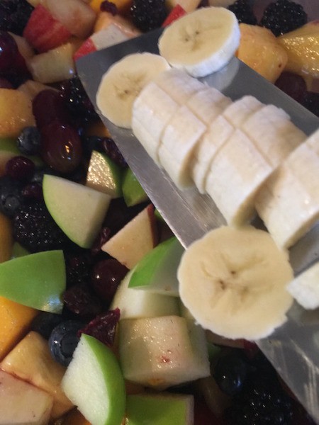 Fruit Salad with Maple Lime Dressing - adding sliced banana