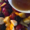 Fruit Salad with Maple Lime Dressing - pouring dressing on fruit