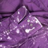 A purple shirt with white paint spatters.