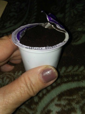 A K-cup with the foil lid removed.