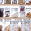 Clear glass jars inside of a pantry.