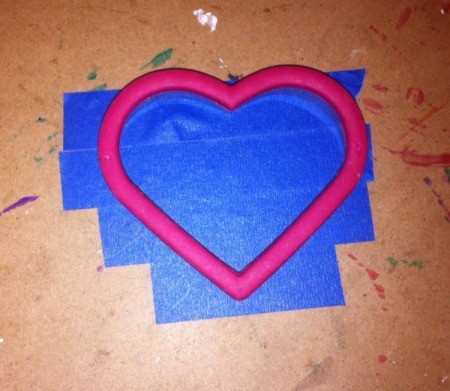 Love and Arrow Finger Paintings - use cookie cutter to trace heart shape on tape, cut out