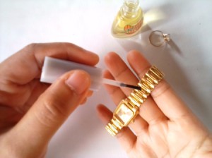 Nail Polish for Shiny Jewelry - applying clear nail polish to a watchband