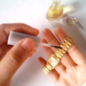 Nail Polish for Shiny Jewelry - applying clear nail polish to a watchband