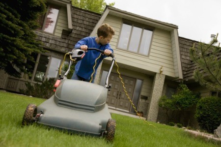 12 year old mowing a lawn.