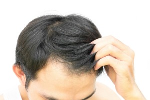 A man touching his hair.