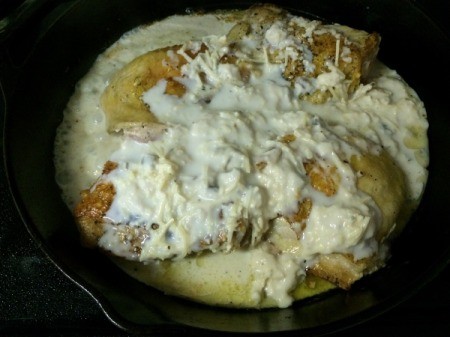 Soup mixture added to chicken in pan