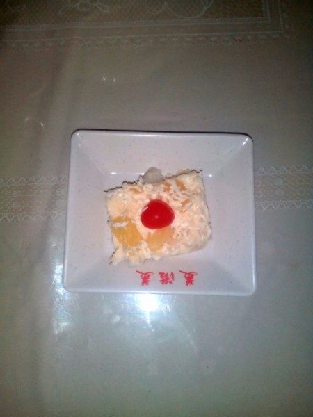 Cut piece of fruity pudding on plate.
