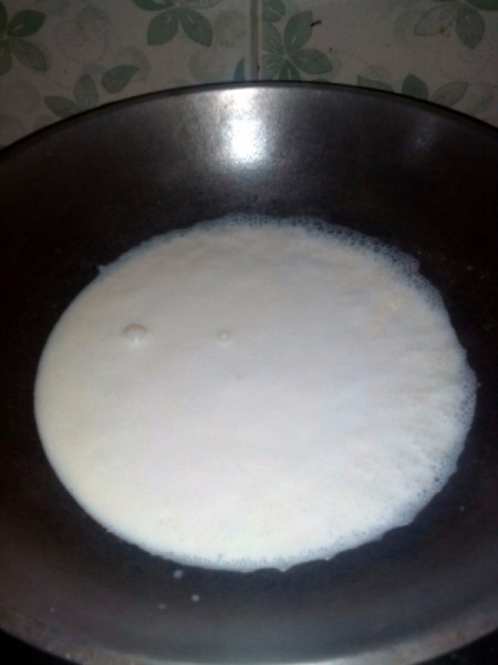 Heating milk in pan.