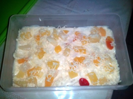 Adding grated cheese to top of pan.