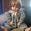 Identifying a Porcelain Doll - doll wearing one piece blue outfit with matching hat