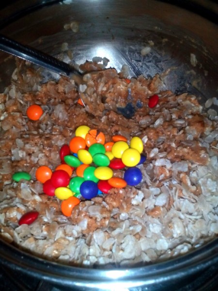 adding candies to peanut butter mix