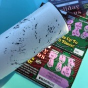 Using a lint roller on a scratch off lottery ticket.