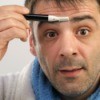A man trimming between his eyebrows.