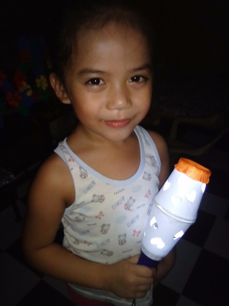 Heart Shapes Flashlight Cover - child with lit heart shapes flashlight