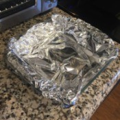 A glass baking pan lined with tinfoil