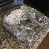 A glass baking pan lined with tinfoil