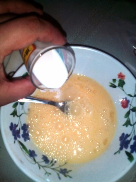 adding milk to eggs