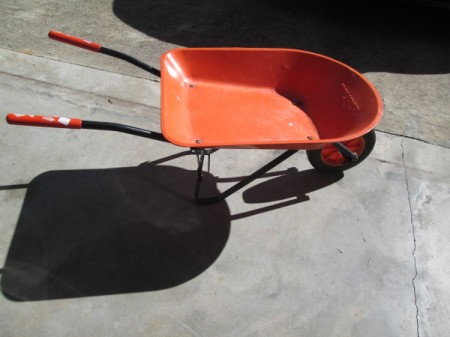 Toy Wheelbarrow as Flower Planter - orange child's wheelbarrow