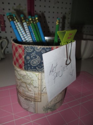 Decorate Food Cans For Office/ or Craft Storage - can decorated with scrapbook paper and wide ribbon holding pencils and a note half on with a clip