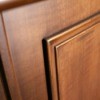 The corner of a wood cabinet door.