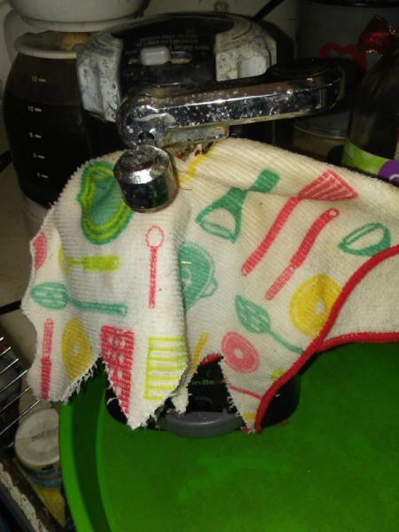 An electric can opener being cleaned with vinegar.