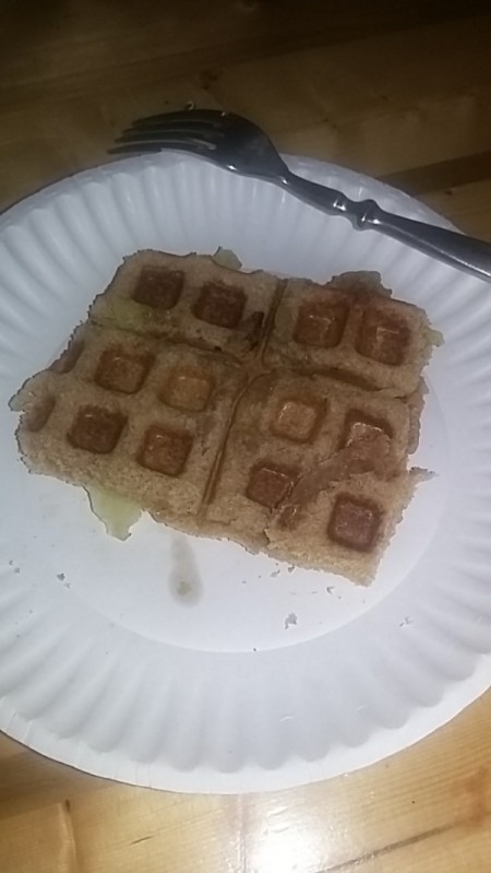 A waffle sandwich made with peanut butter and bananas.