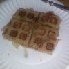 A waffle sandwich made with peanut butter and bananas.