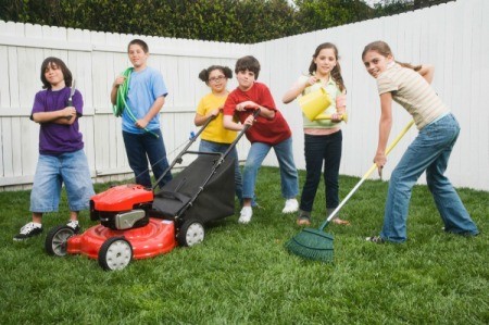 A group of tween aged kids doing yard work.