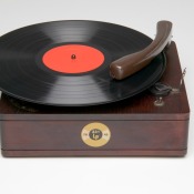 An antique record player with a record playing.