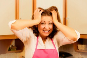 A worried woman in the kitchen.