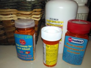 Several bottles of prescriptions on a counter.