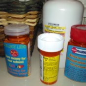 Several bottles of prescriptions on a counter.