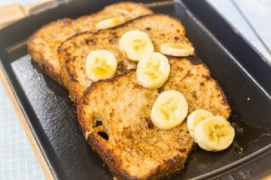 French toast slices in a pan with banana slices.