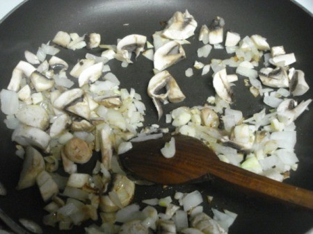 frying mushrooms, garlic, onions and ginger in pan