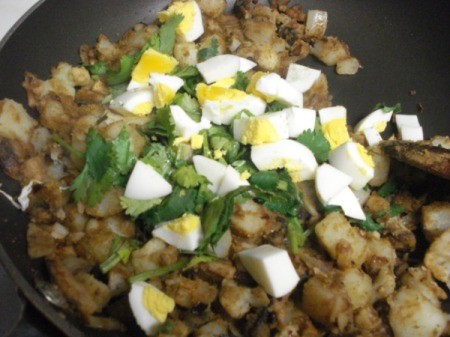 Adding chopped egg and cilantro to pan