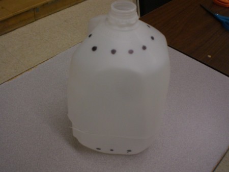 Starting Seeds in the Snow - marks for holes around the top of jug