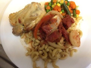 chicken Paprikas on plate with macaroni and mixed vegetables