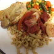 chicken Paprikas on plate with macaroni and mixed vegetables
