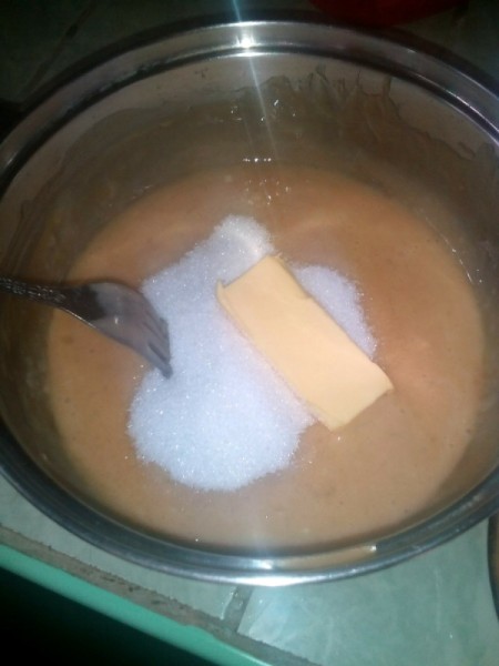 adding sugar and butter to banana mix