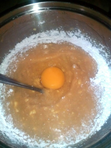 egg added to batter in bowl