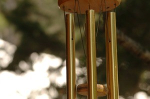 A hanging wind chime made from metal bars.