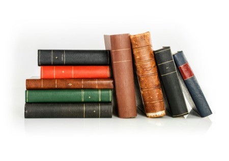A bunch of antique looking hardcover books.