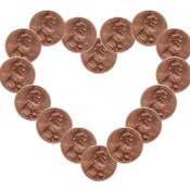 A heart made out of pennies on a white background.