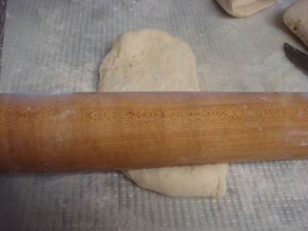 rolling pizza dough piece