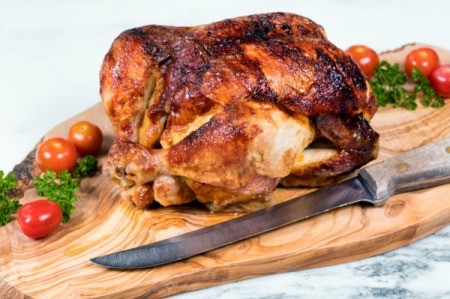 A rotisserie chicken, ready for carving.