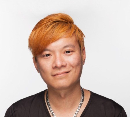 A young man with orange hair.