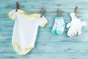 Baby clothes hanging up.